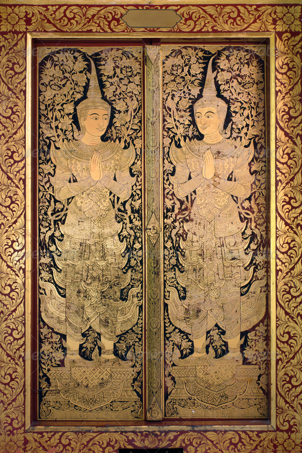 Thai ancient art Gold angel painting on church door in Wat phra singh, Chaing Mai, Northern of Thailand