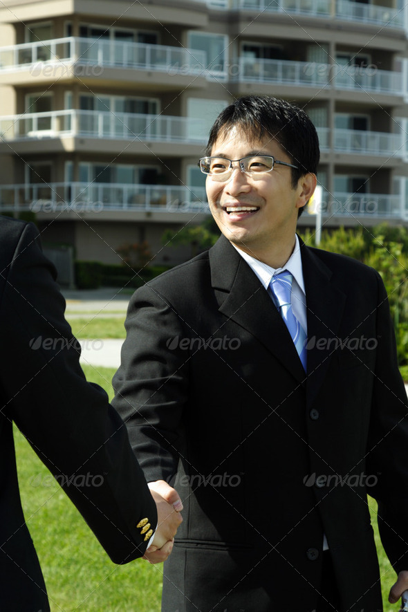 Two businessmen shaking hands on a deal