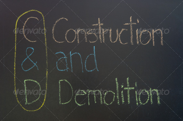 C&D acronym Construction and Demolition,construction concept ,color chalk handwriting on blackboard