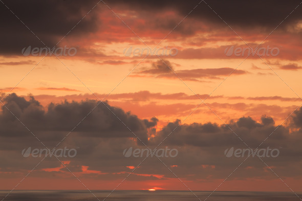 Sunset in the ocean with clouds