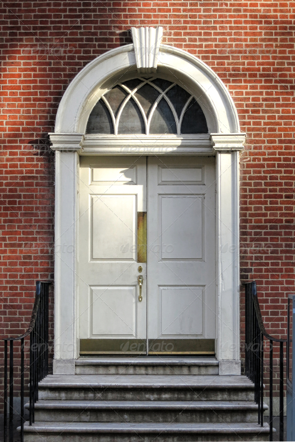 Georgian colonial architecture style old historic building entry door and steps with Adams detail semicircular fan lite above and keystone lintel at Independence Hall in Philadelphia Pennsylvania