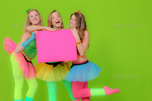 Fashion girls in neon clothing holding blank pink board