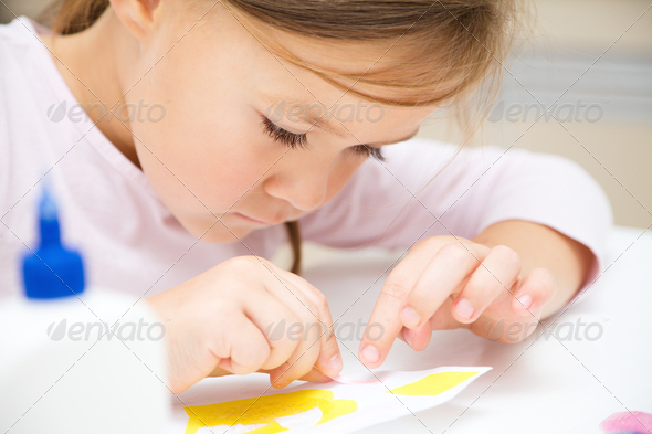 Little girl doing arts and crafts in preschool