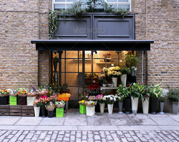 Flower shop exterior in street with brickwall facade
