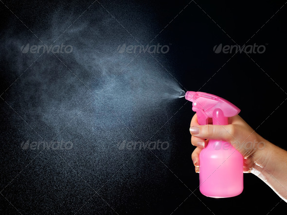 Using of a spray nozzle on a black background.