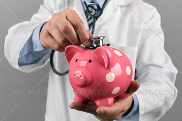 Doctor with piggy bank and stethoscope concept for financial checkup or saving for medical insurance costs