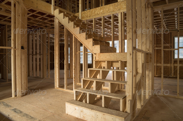 new house construction interior with exposed framing and stairs