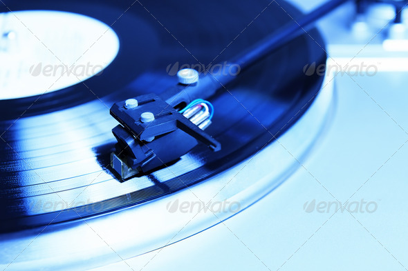Turntable playing vinyl record with music