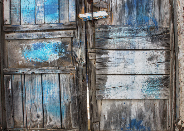 Old rotten door with blue paint