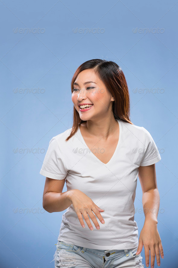 Young happy Chinese female model on colorful background.