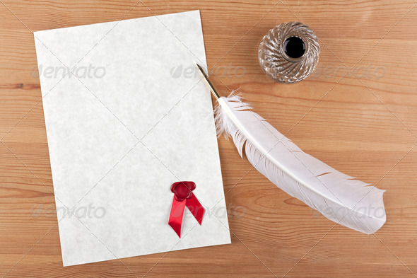 A blank piece of parchment paper with red wax seal, plus feather quill and glass ink well on a desk, add your own text for a certificate, diploma or important document.