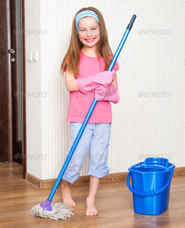 happy pretty girl washing the floor with a mop at home