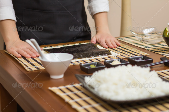 Woman chef ready to prepare japanese sushi rolls