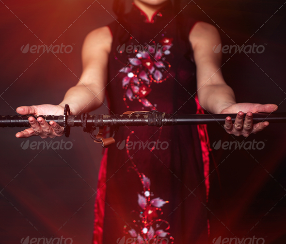 Woman with japan sword katana in hands