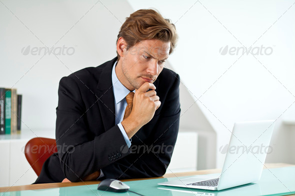 Concerned Businessman in front of laptop