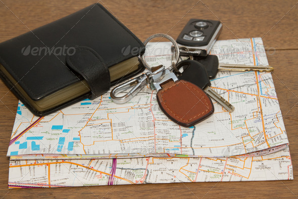 Wallet and car keys on the road map, concept travelling on vacat