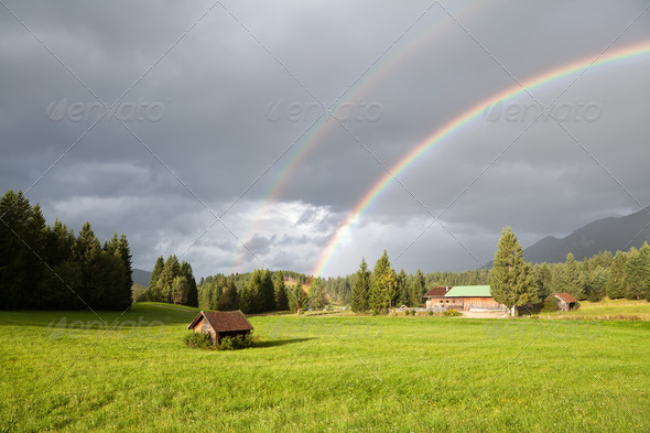 colorful rainbow during rain in Alps
